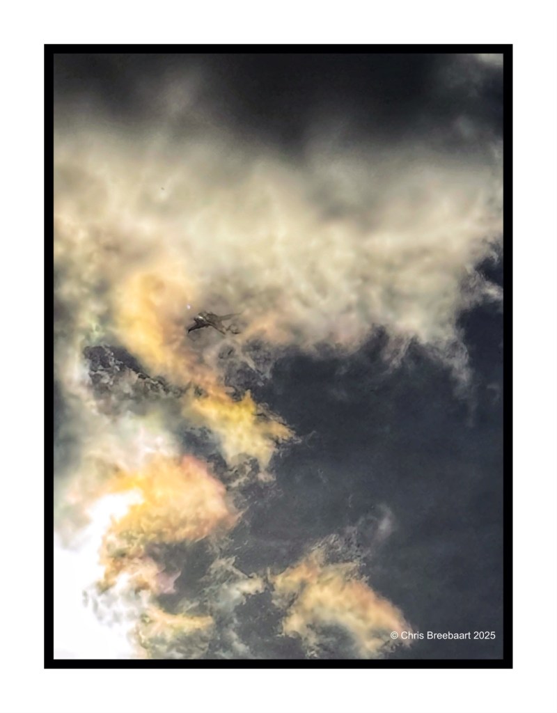 A dramatic sky filled with dynamic clouds showcasing a mix of colors and light.