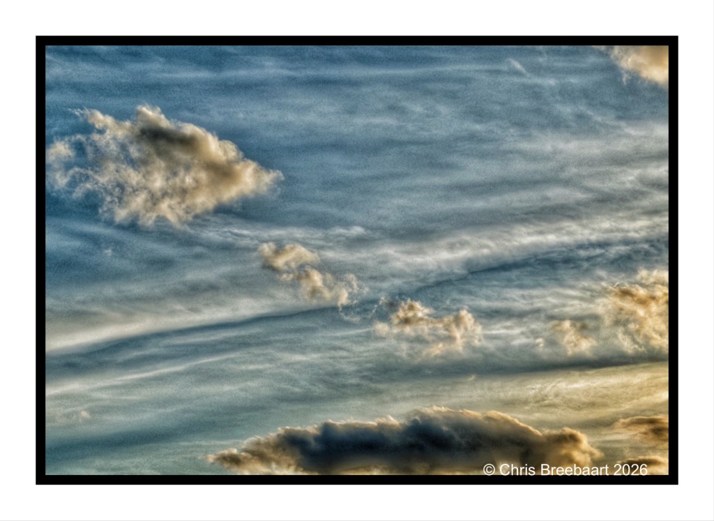 A scenic view of a blue sky filled with various clouds, showcasing different shades and textures.